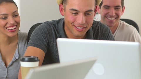 Close up of diverse group of office workers at laptop