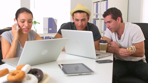 Diverse group of coworkers working together on laptop