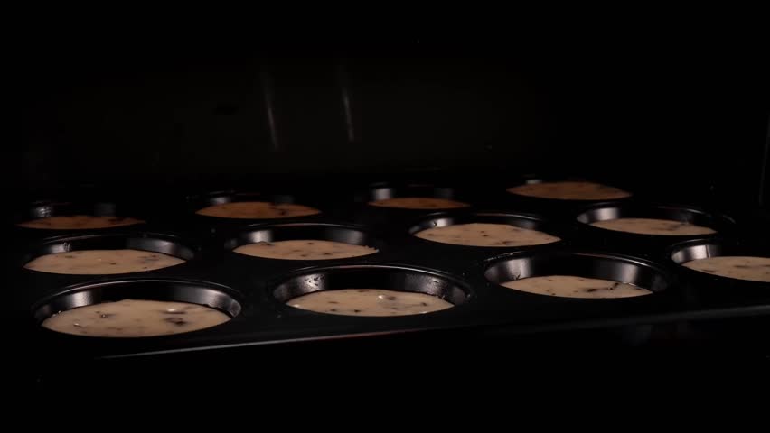 Homemade muffins baking in oven . Timelapse of freshly baked croissants , camera move