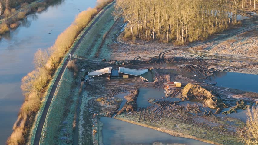 construction new dam water guidance facility next to river ongoing works overflow reservoir aerial shot engineering infrastructure project environment landscape