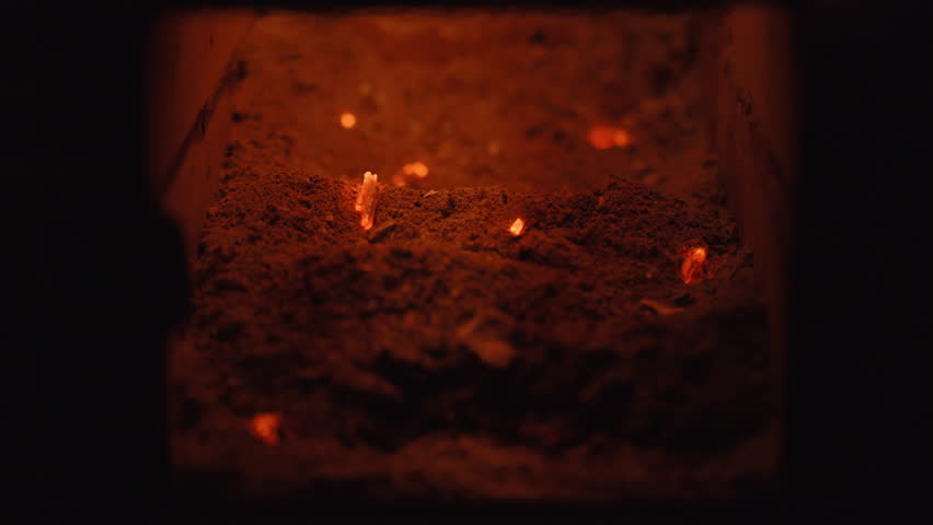 Captivating CloseUp Footage of Glowing Embers Set Against Dark Ash, Creating a Unique Atmosphere and Ambience