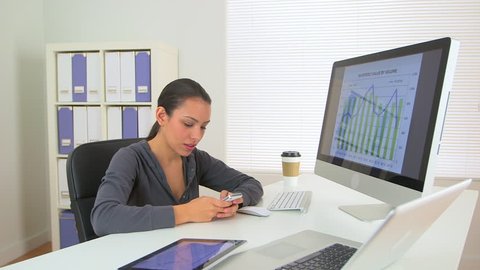 Happy Hispanic business woman excited at desk