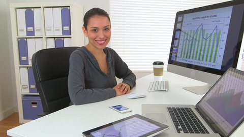 Mexican business woman working on laptop and phone