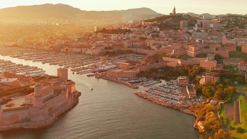Aerial view of the historic Vieux Port in Marseille at sunrise, southern France. A beautiful summer morning highlights the Marseille cityscape, the second-largest city in France