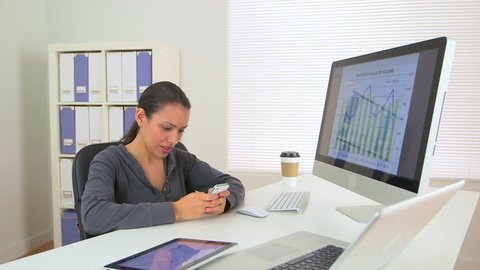Happy Latina business woman excited at desk