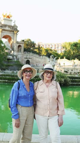 Happy senior women friends posing together in parc de la ciutadella, barcelona