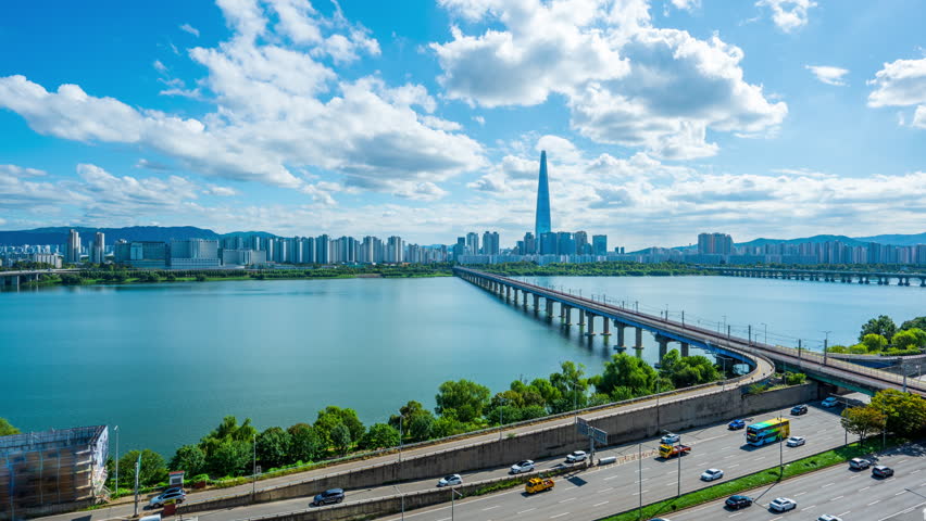 4k Time lapse, Traffic on the road along the Han River and the view of Seoul during the day