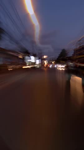 Nighttime travel along a busy street with moving lights. POV. Vertical video