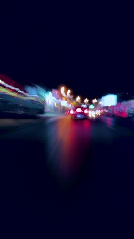 City night drive with colorful lights and dynamic motion effects. Vertical video