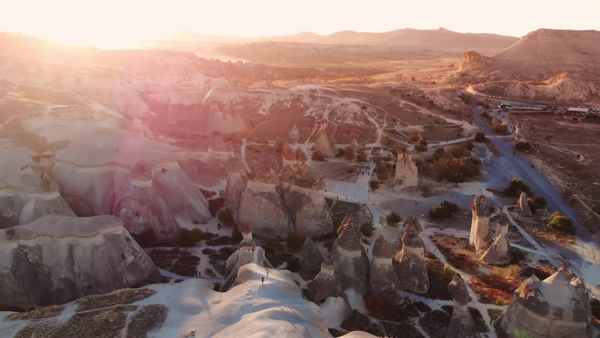 Aerial view of sunset over Cappadocia unique landscape with majestic rock formations.