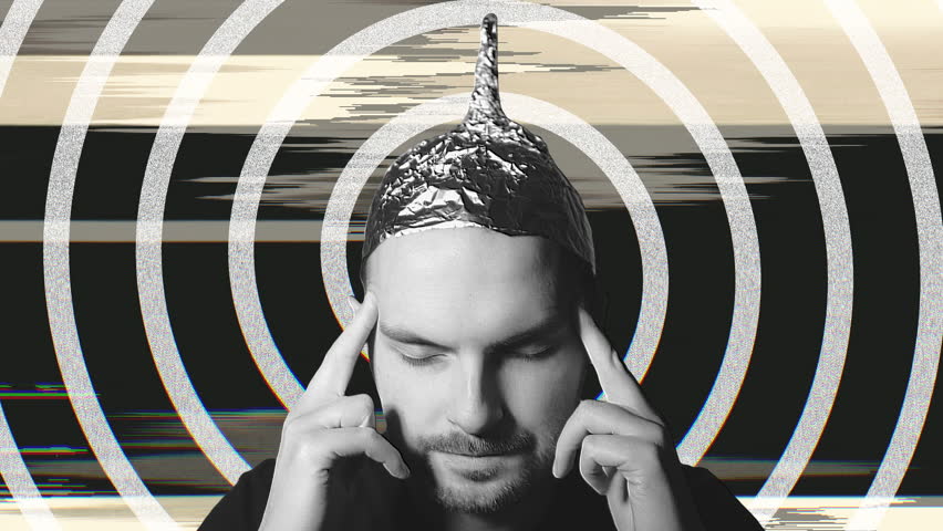 Man wearing tin foil hat concentrating intently, blocking external influences with closed eyes and fingers on temples against colorful digital glitch backgrounds