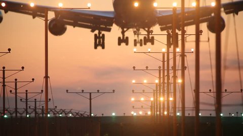 Big airplane plane landing in airport at sunset Stock Video