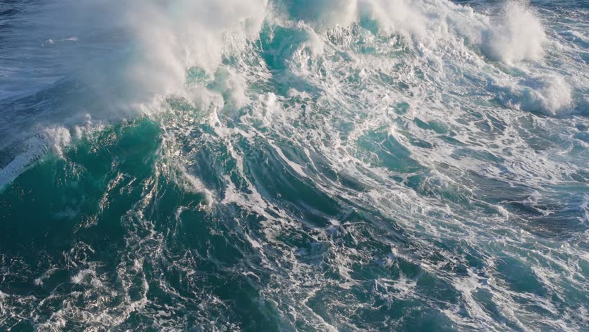Big power ocean waves with white foam in Atlantic Ocean. Aerial slow motion shot of fabulous sea tide on stormy day