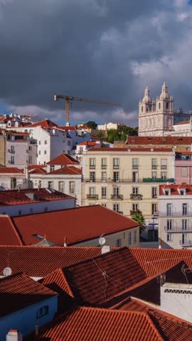 Time-lapse of Lisbon famous view from Miradouro de Santa Luzia tourist viewpoint over Alfama old city district, cruise liner and moving clouds. Lisbon, Portugal. Camera pan