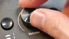 Hand adjusting volume knob to maximum, close-up of audio control, turning sound dial to max, increasing speaker volume, adjusting amplifier knob, sound system control, stereo tuning, music volume up - Powered by Shutterstock - Get 15% off with code: PIKWIZARD15