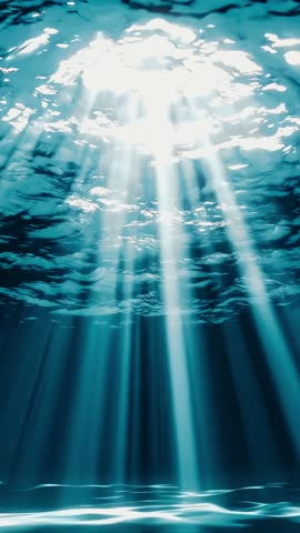 Underwater Light Rays that Feature Sunbeams Breaking Gently Through the Water Surface