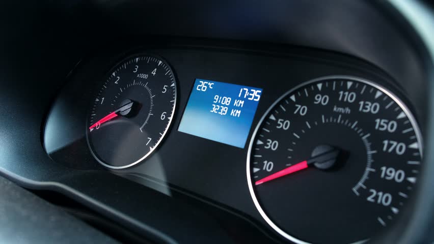 Dashboard of modern low-cost budget car with analog arrows. Speedometer and tachometer for driver of car. Turning on all car's instruments before starting. On-screen caption - "Function check"