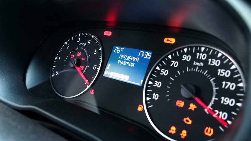 Dashboard of modern low-cost budget car with analog arrows. Speedometer and tachometer for driver of car. Turning on all car's instruments before starting. On-screen caption - "Function check"