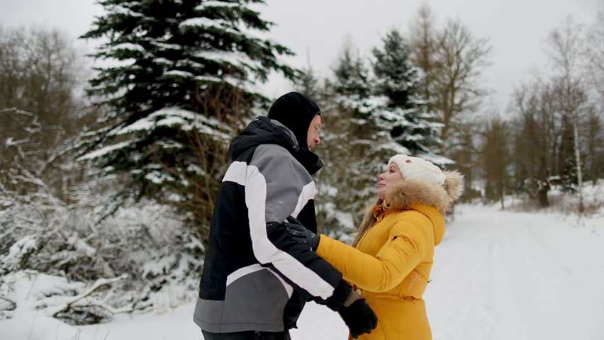 couple in love kisses in the snowy forest