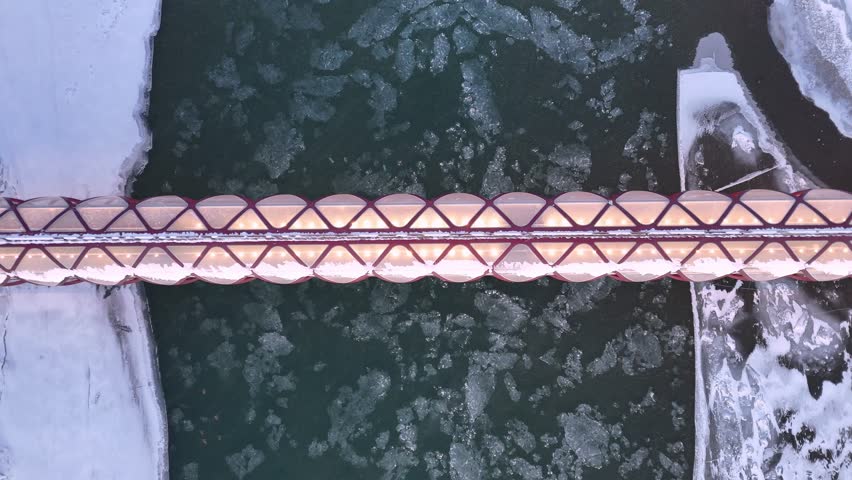 Ice floating on the Bow River under the Peace Bridge on a freezing winter day.