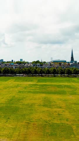 Vertical video. The Hague, Netherlands. Malieveld is a large grass field in the center of The Hague with an area of over ten hectares. Summer day, Aerial View. Rich colors