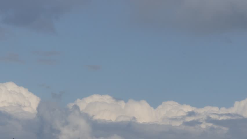 Beautiful White Cumulonimbus Fluffy Clouds Moving on the Sky. Rainy Clouds in a Slideshow on the Sky in a Summer Day.