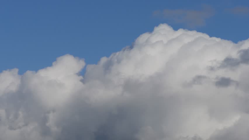 Beautiful White Cumulonimbus Fluffy Clouds Moving on the Sky. Rainy Clouds in a Slideshow on the Sky in a Summer Day.