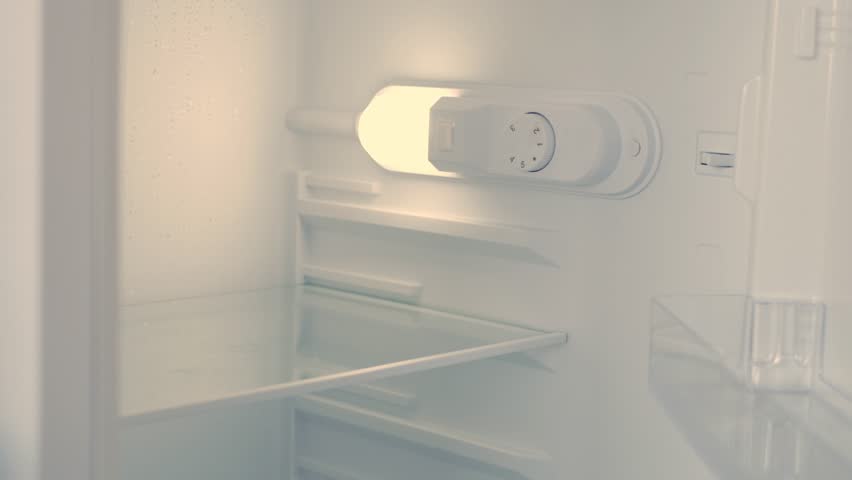 Man Hand Opens an Empty Fridge Door Looking Inside for Fresh Food and Drink. Empty Fridge, Food Crisis Concept.