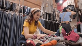 Young teen tourist Gen Z asia female choose look at zero waste eco go green buy heap second hand sale store flea market thrift old used vintage fabric style. Happy woman asian people small retail shop - Powered by Shutterstock - Get 15% off with code: PIKWIZARD15