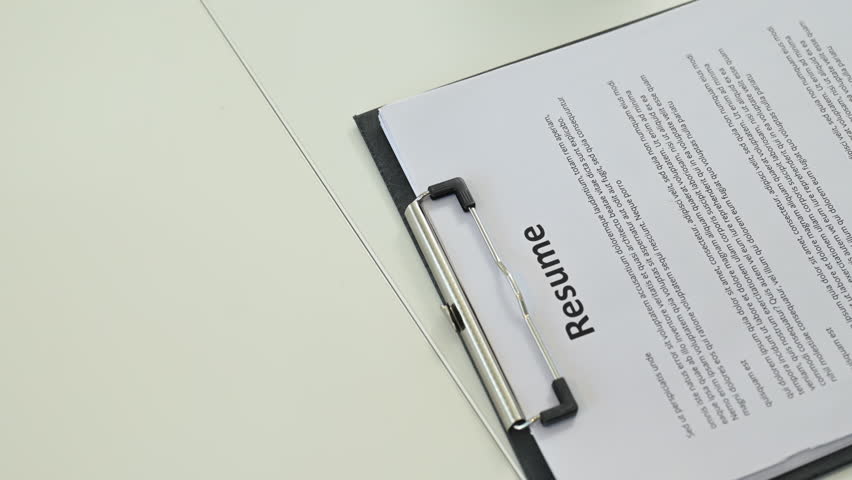 Resume document on white desk, job application and recruitment concept