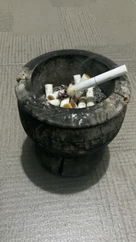 A video of raindrops falling at night, accompanied by the soothing presence of a single cigarette, creating a truly pleasurable moment.