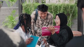 Focused Indonesian students reading notes and studying together for University exams in the cafeteria - Powered by Shutterstock - Get 15% off with code: PIKWIZARD15