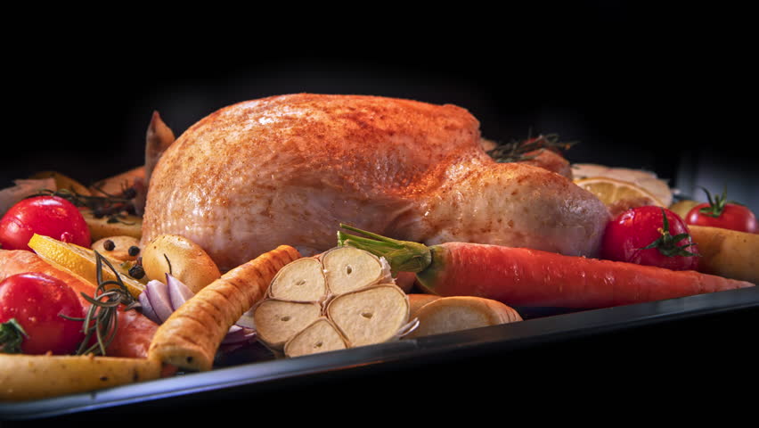 Timelapse Shot of Baking Whole Chicken and Vegetable Garnish with Camera Motion.