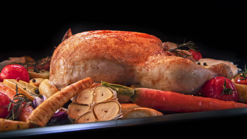 Timelapse Shot of Baking Whole Chicken and Vegetable Garnish with Camera Motion.