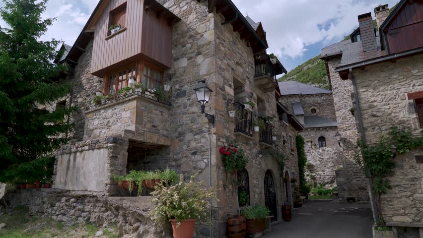 Typical medieval village in the Pyrenees, with stone houses and a traditional church with its tower, from Lanuza, Sallent de Gállego, Huesca, Aragon, Spain, Europe.