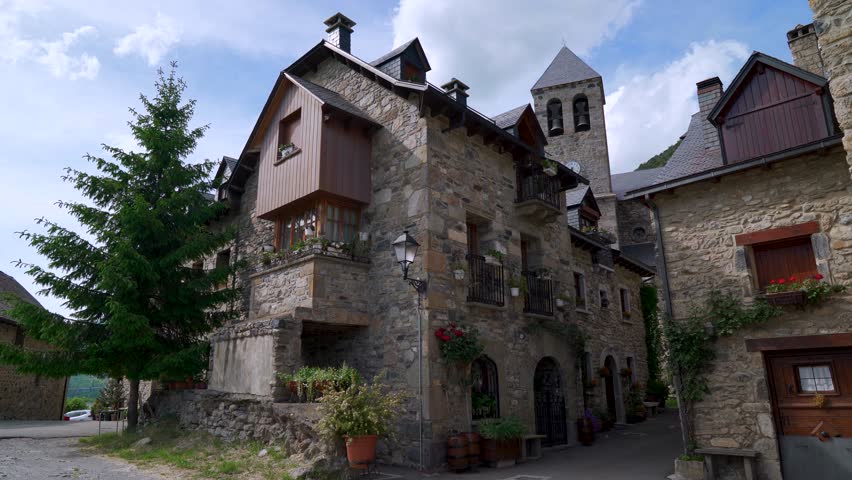 Typical medieval village in the Pyrenees, with stone houses and a traditional church with its tower, from Lanuza, Sallent de Gállego, Huesca, Aragon, Spain, Europe.