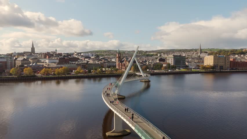 City of Derry aka Londonderry in Northern Ireland aerial view - A Beautiful Cityscape from above by the River Foyle Featuring the Beautiful Pedestrian Peace Bridge