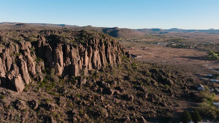 Beautiful cliffs at sunrise overlooking deserted small Texas town, aerial 4k orbit