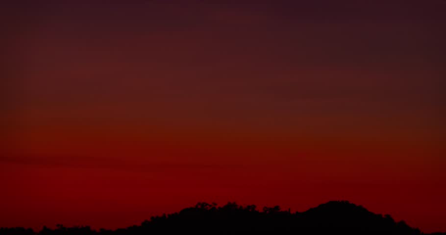 Beautiful Timelapse sunrise in golden sky background,Amazing sun clouds over mountains nature background
