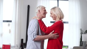 elderly couple in love celebrates Valentine's Day at home and kisses, old man talks and flirts with his wife, retired people in love - Powered by Shutterstock - Get 15% off with code: PIKWIZARD15