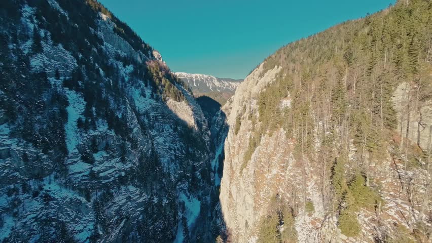 FPV drone flight into Zarnesti Gorges, capturing stunning winter landscapes, forested cliffs, and serene Carpathian beauty