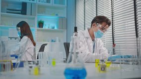 Asian male and female scientists work together in the research laboratory. Attractive man technician using laptop device conducting tests for chemistry biotechnology research and medical development. - Powered by Shutterstock - Get 15% off with code: PIKWIZARD15