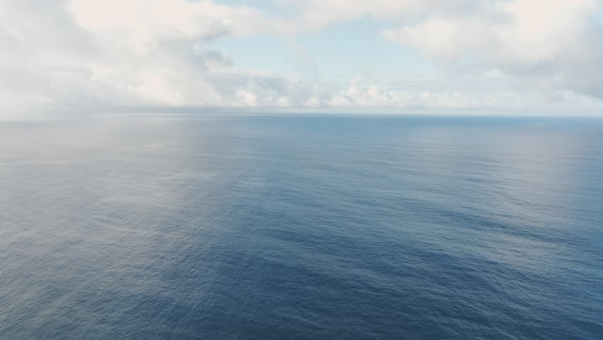 Aerial view of seascape of South Pacific Ocean with clouds in sky. Cook Islands.