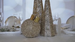 Beautiful gold holiday decorations with sparkling ornaments and glasses, perfect for festive events. - Powered by Shutterstock - Get 15% off with code: PIKWIZARD15