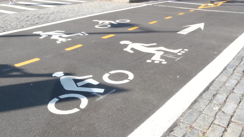 Bike lane asphalt sign, New York City. Bicycle path, cycle route for bicyclists, Manhattan. Way for roller skating and skates. Recreational sport activity infrastructure, biker cycling, United States.