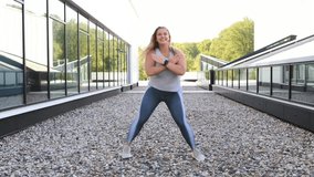 Happy Smiling Plus-Size Woman Dancing Outdoors in City, Joyful Curvy Female model in Tight Leggings Expressing Positivity and Confidence on Bright Urban Street - Powered by Shutterstock - Get 15% off with code: PIKWIZARD15