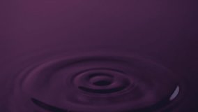 A drop lands on a smooth pink-purple water surface, producing a crown splash and spreading concentric ripples in slow motion. - Powered by Shutterstock - Get 15% off with code: PIKWIZARD15