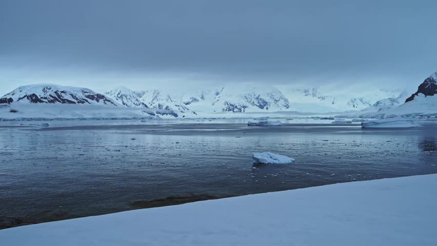 Dark Moody Winter Coastal Seascape, Antarctica Ocean Scenery with Iceberg Mountains and Sea, Beautiful Dramatic Blue Coast Landscape on Antarctic Peninsula, Icy Winter Sea Scene with Ice