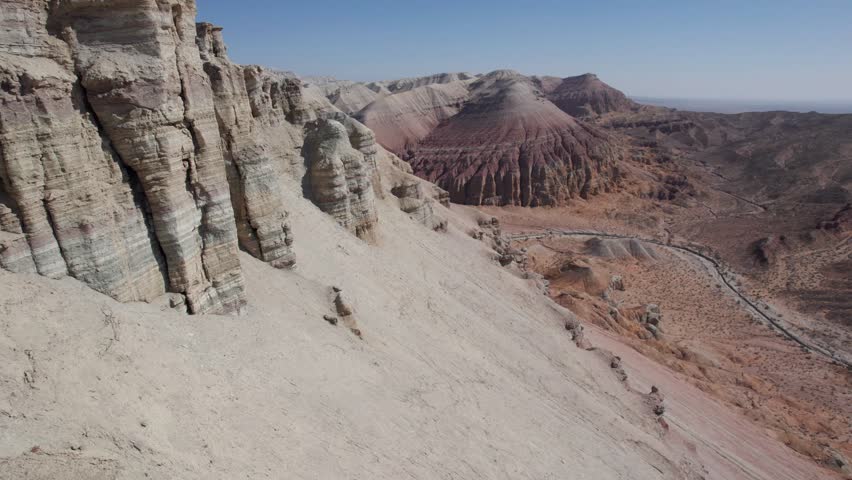 The chalk mountains are like a layered colored pie. Aerial view of the gorge where water used to run, white peaks and red edges. Paleontological deposits. Like high bastions, rocks of unusual shapes