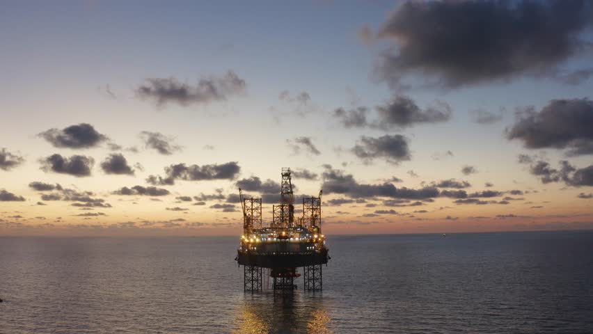 Aerial view of an offshore jack up drilling rig during sunset - oil and gas upstream industry
